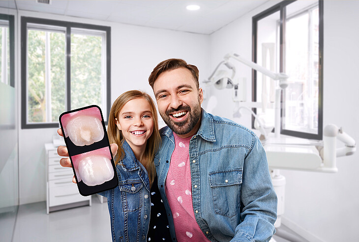 Father and daughter present her successfully treated teeth